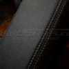 Contrasting frost stitching on black leather console lid cover