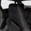 Black leather headrest close-up with contrasting Red double-stitching