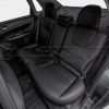 Driver side view of installed black leather rear seats in Subaru Impreza