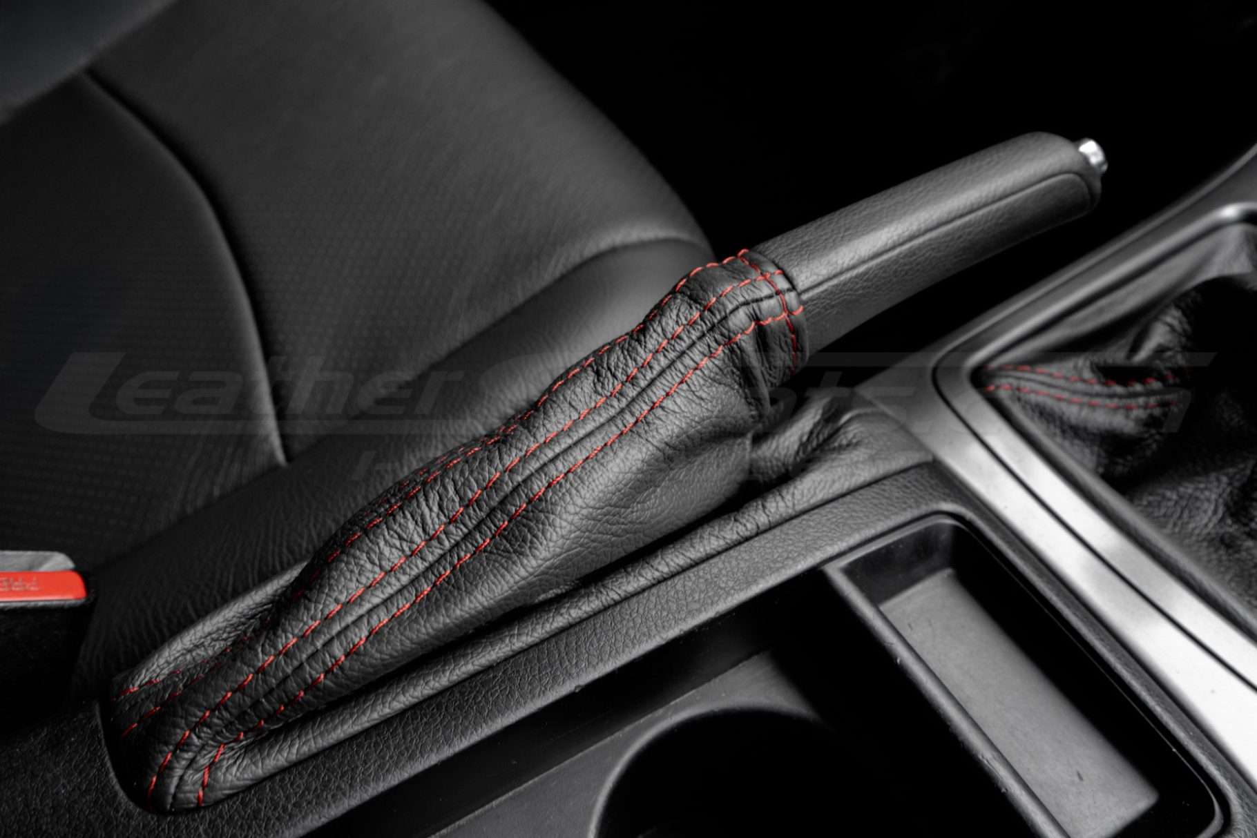 Top-down passenger view of installed aftermarket leather ebrake cover for WRX premium