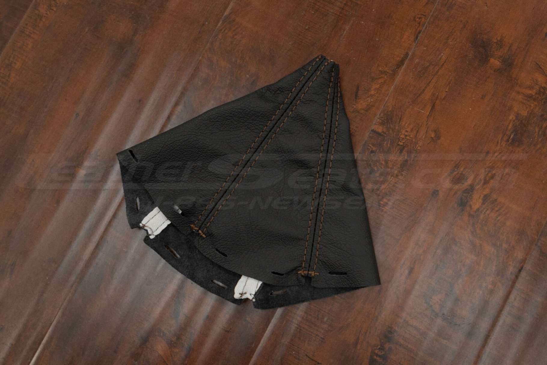 Flat lay side view of manual shift boot upholstery for acura integra