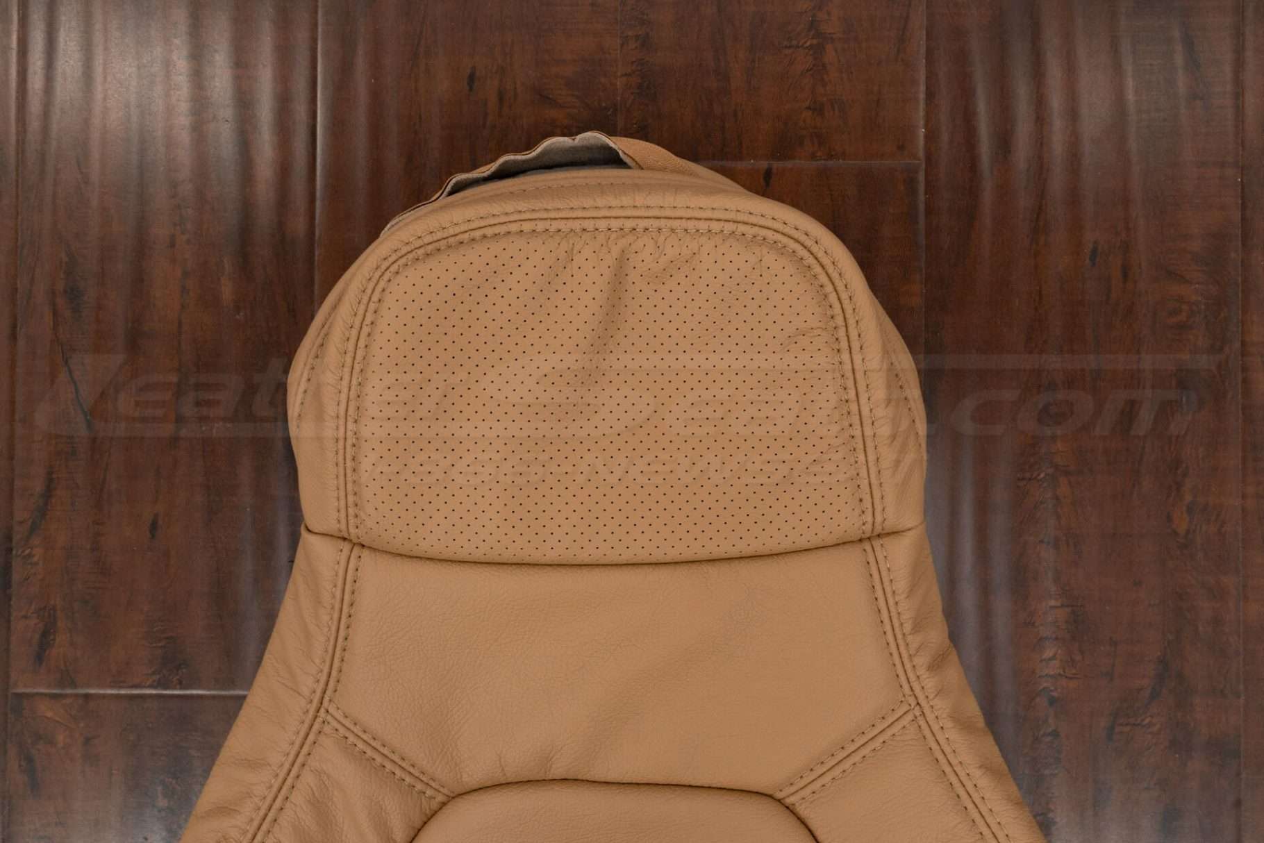 Upper section of tan mazdia miata backrest upholstery with perfrated headrest section