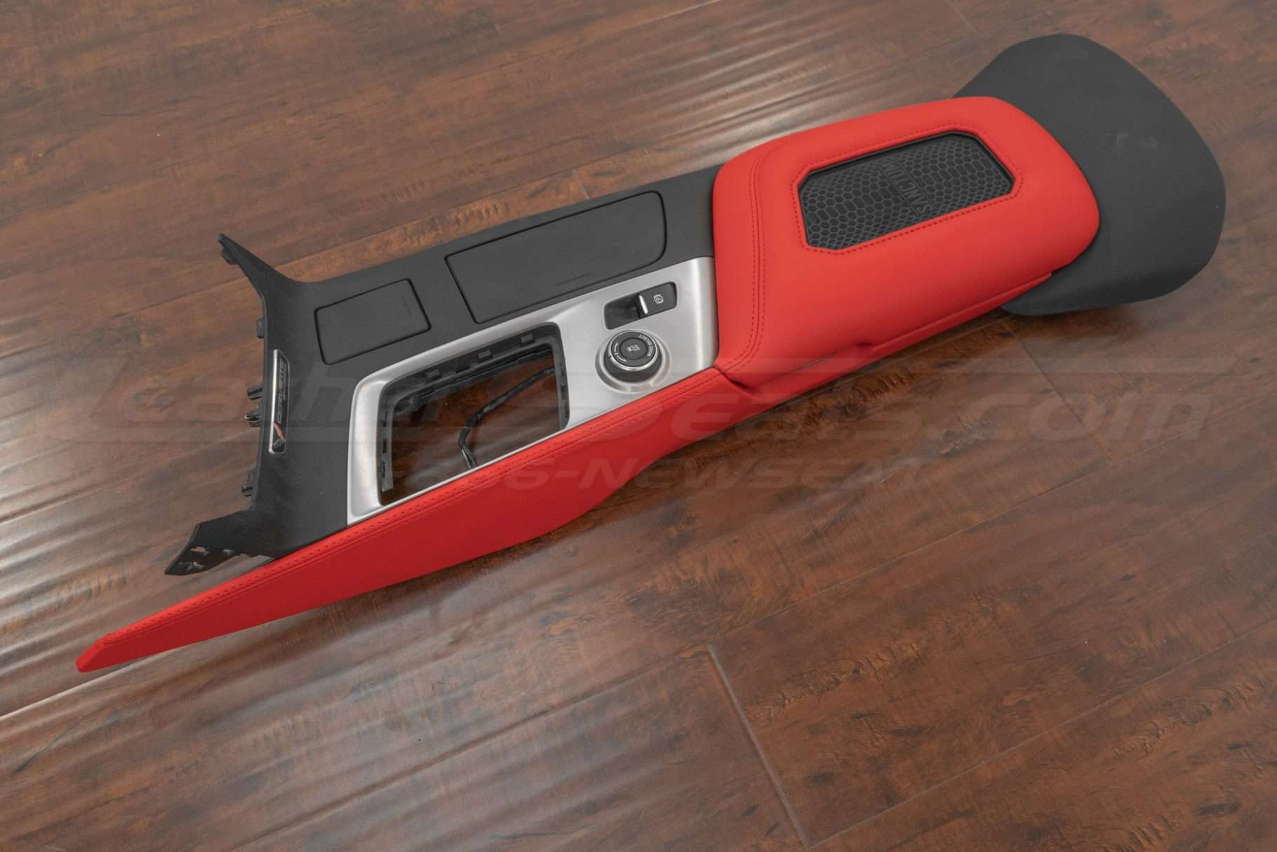 Top down view of corvette wireless charging console lid with leather thigh extension in bright red