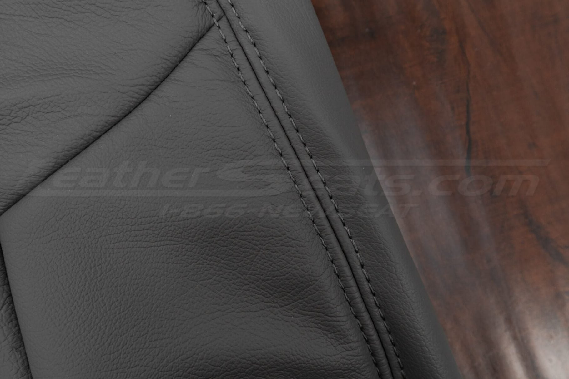 Light grey stitching on light grey leather close-up