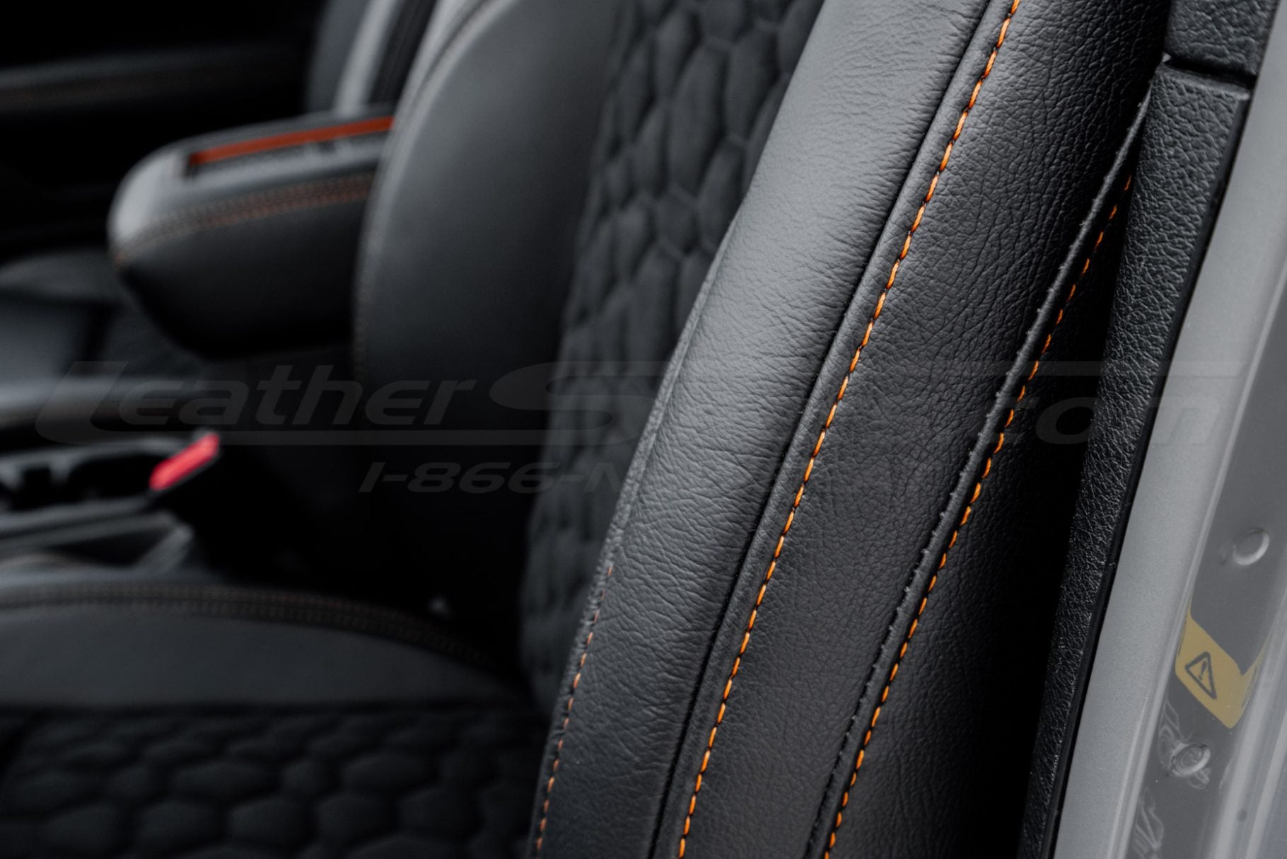 Contrasting Orange stitching on Black leather