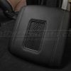 Low side view of qi2 charging console lid in black leather with smoke stitching and trim ring