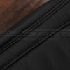 Black double-stitching on black leather