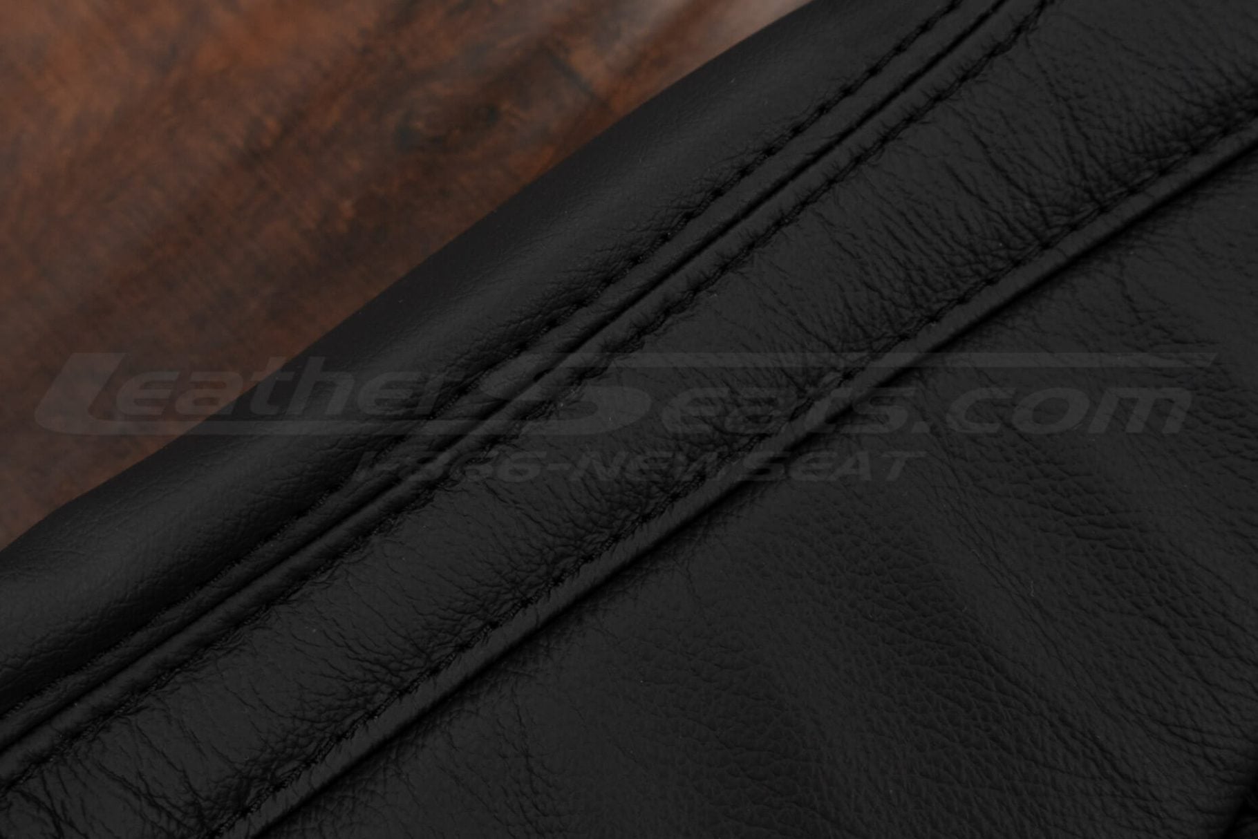Black double-stitching on black leather