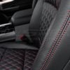 Red double-stitching on black leather