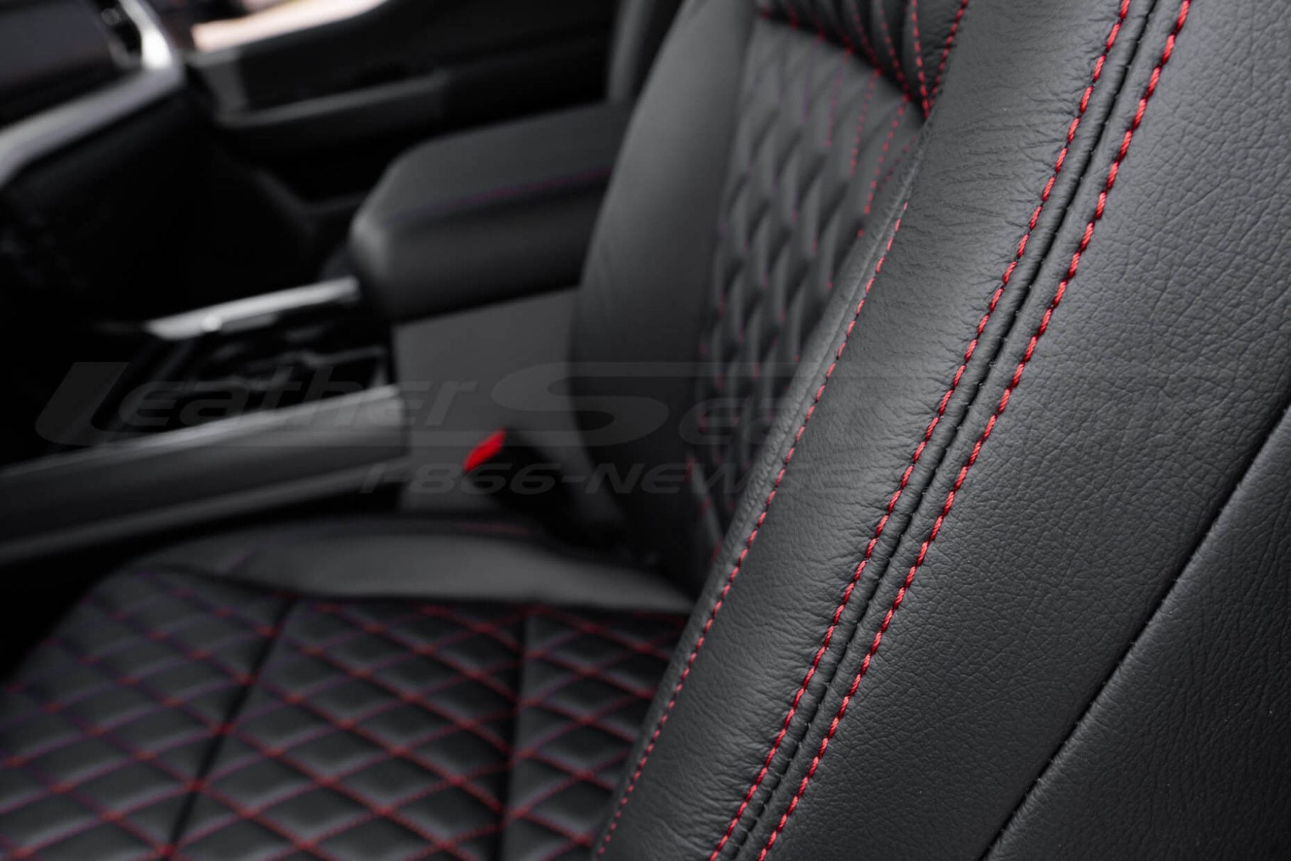 Red double-stitching on black leather