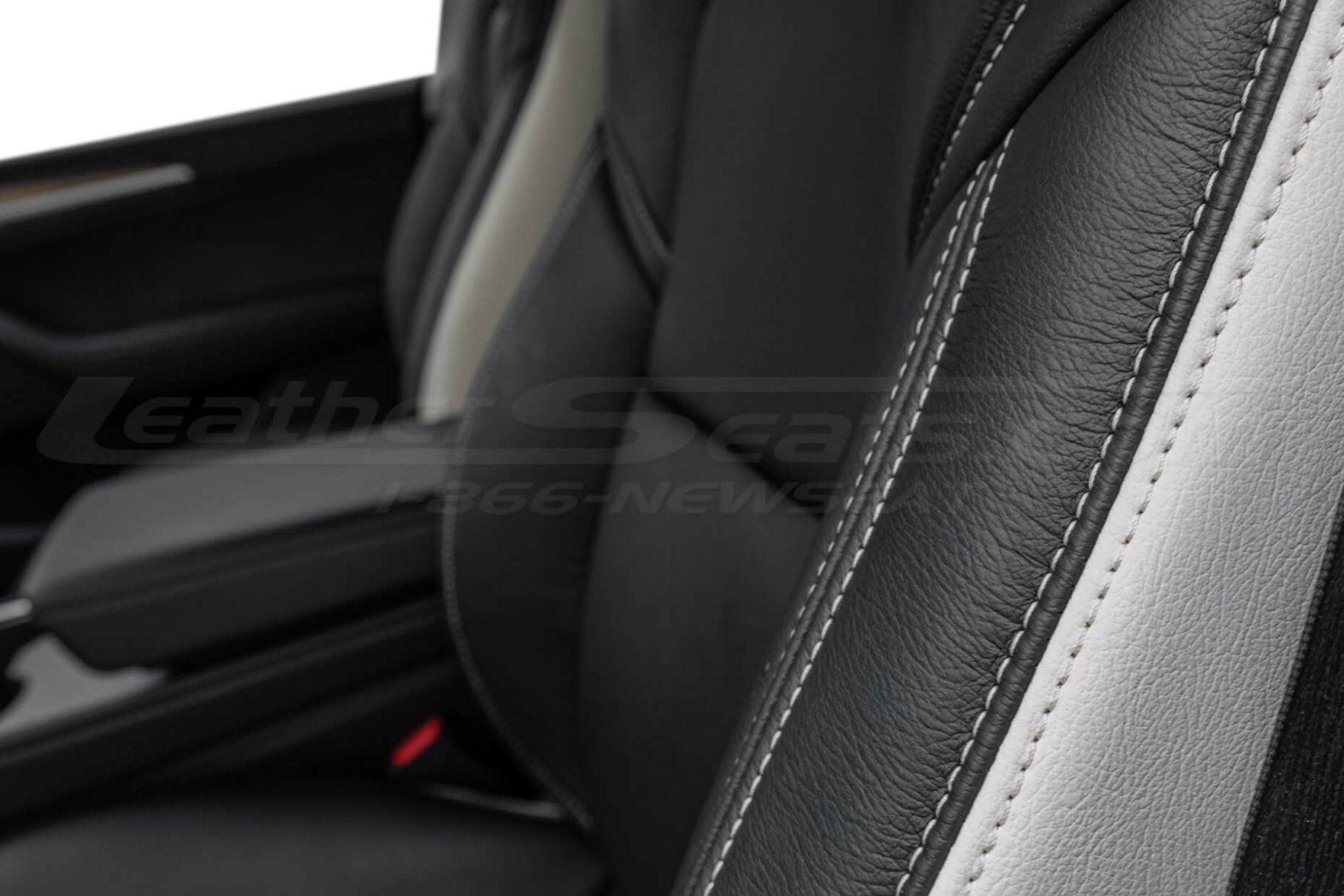 White double-stitching on white and black leather