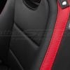 Close-up of Chevrolet Camaro black leather seat with red stitching and side airbag label