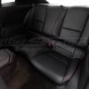 Rear seats of a Chevrolet Camaro in black leather with red stitching