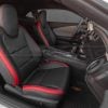 Chevrolet Camaro cabin featuring custom black leather seats with vibrant red accents and stitching
