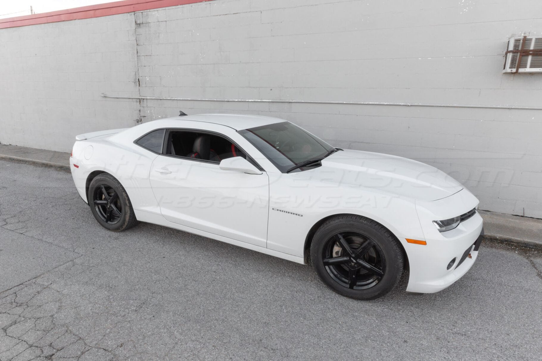 Side profile of a white Chevrolet Camaro, showcasing its sleek design