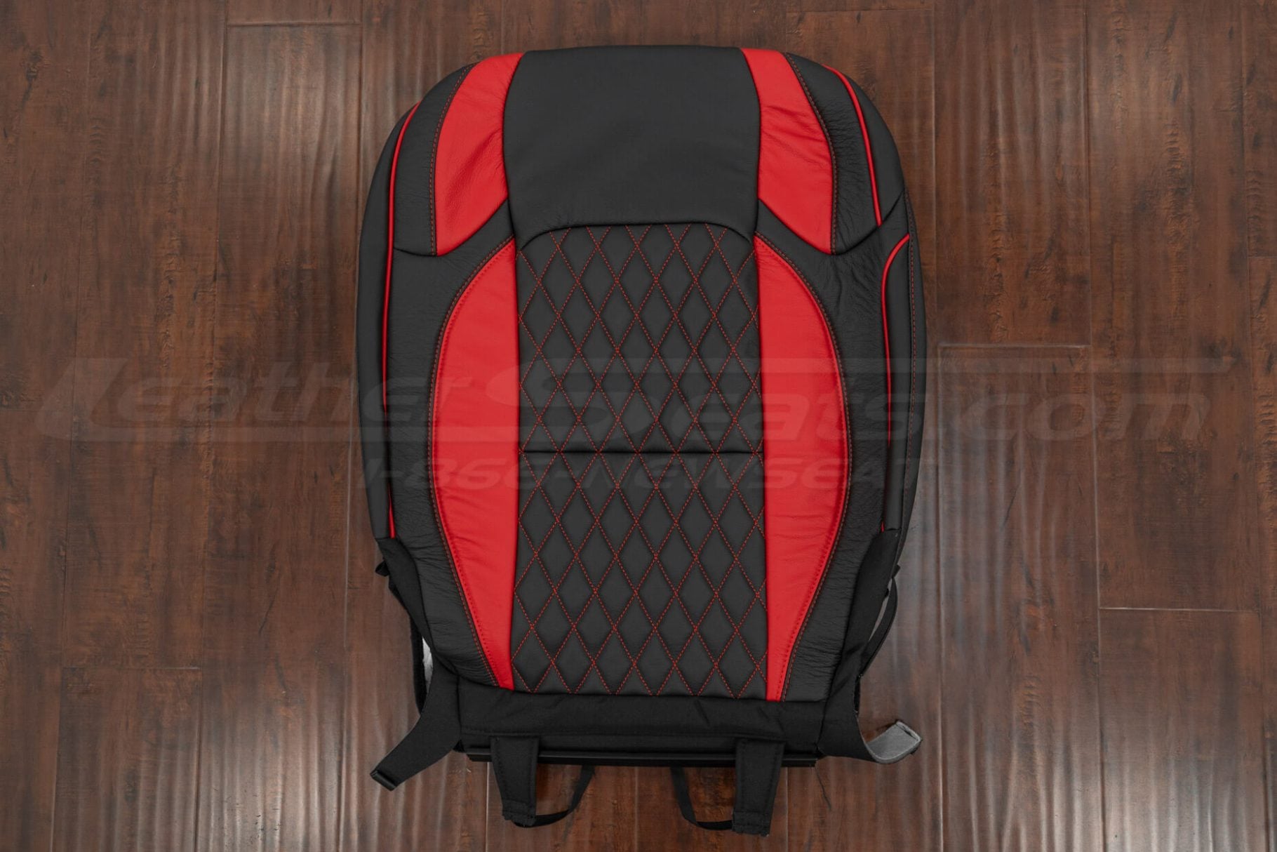 Full black and red leather Jeep Wrangler JL seat backrest with diamond stitching and red side panels placed on wooden floor.