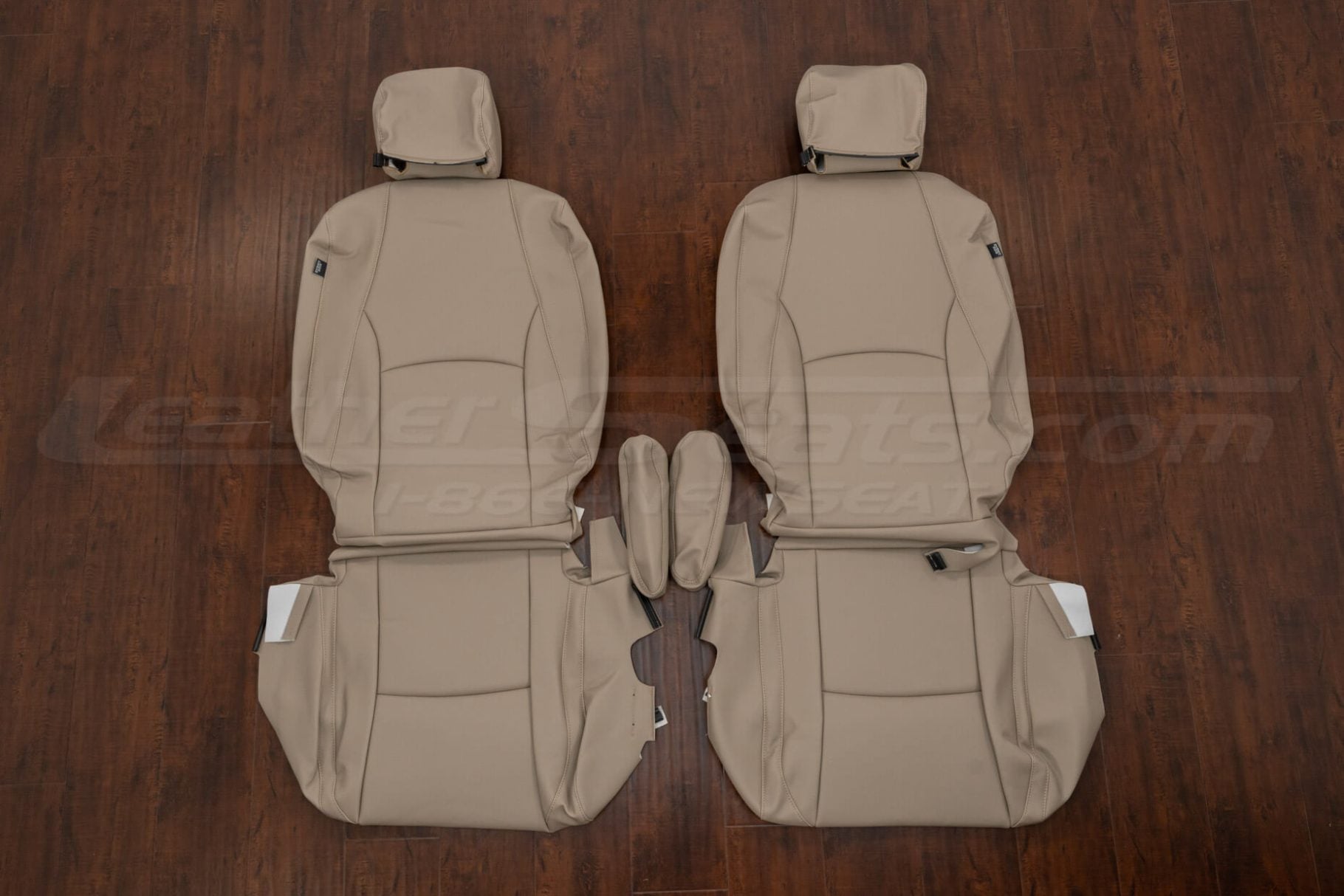 Front seat leather upholstery kit for 2004–2009 Lexus RX 330, RX 350, and RX 400h in ivory/beige – includes driver and passenger seat covers with headrests and console pieces laid flat on wood flooring.