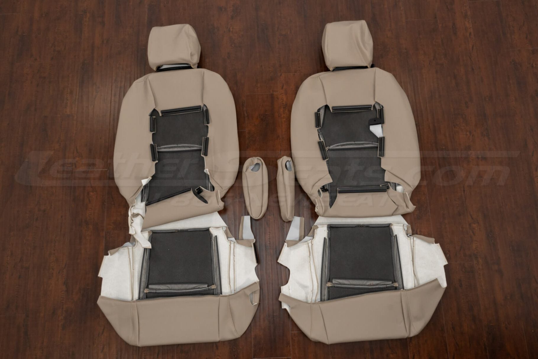 Underside view of beige front seat upholstery covers for Lexus RX series, showing installation foam backing and attachment points for driver and passenger sides.