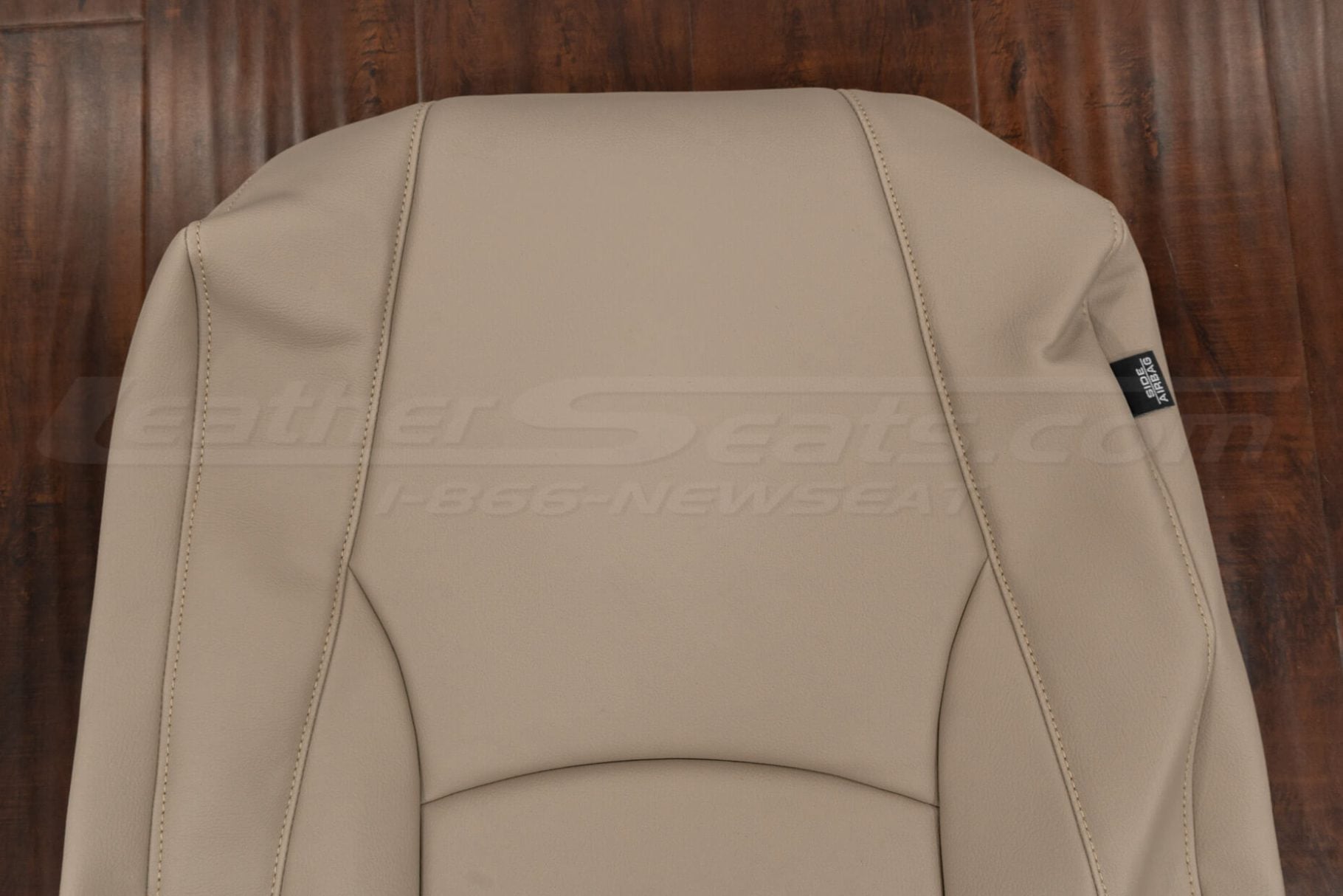 Close-up of Ivory leather front seat backrest cover for Lexus RX, showing fine grain texture, seam detail, and side airbag tag