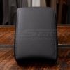 Premium leather CR-V console armrest cover displayed upright on wood grain surface.