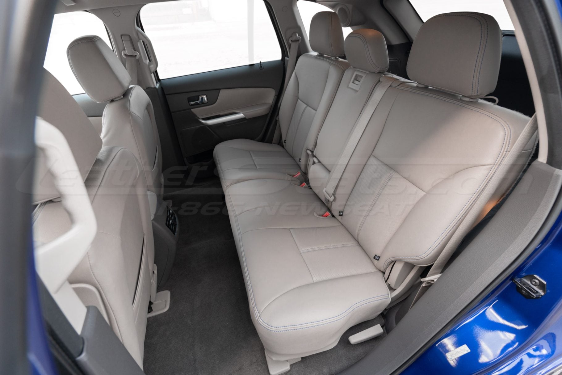 Driver side installed leather upholstery in OEM Medium Light Stone