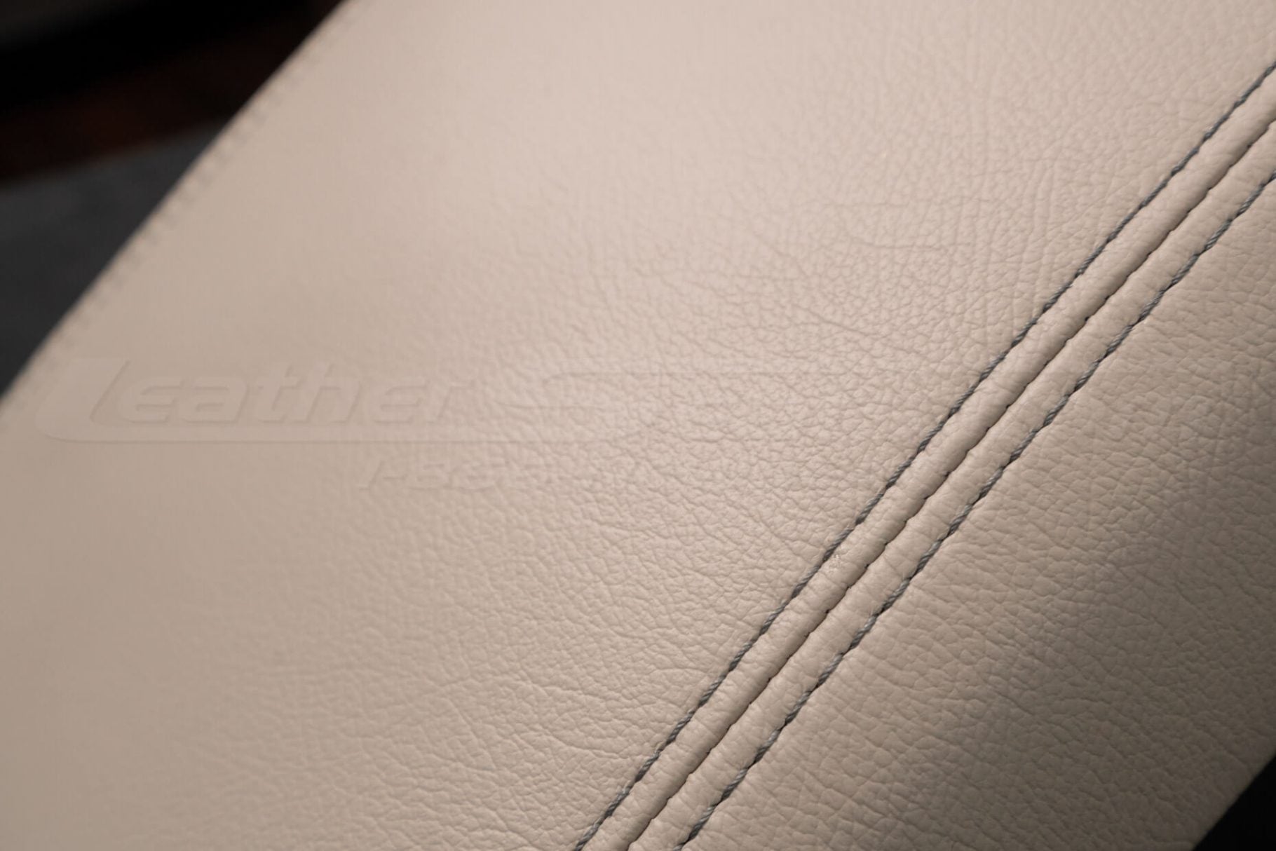 Contrasting charcoal stitching on canvas leather console