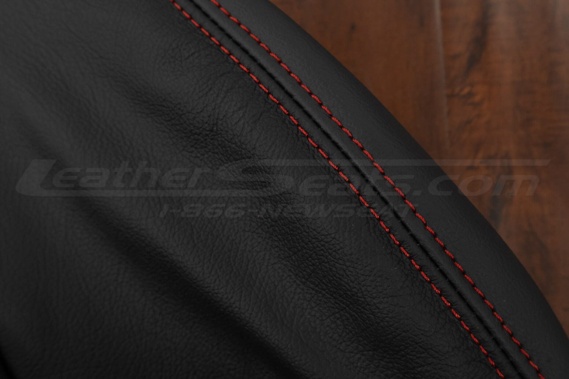 Contrasting Red double-stitching on black leather for corvette