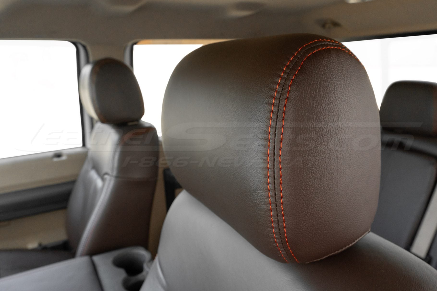Ford Superduty with Coffee leather headrest cloe-up and contrasting tangerine orange stitching