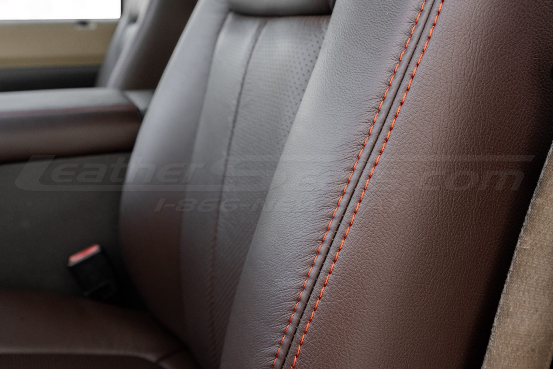 Contrasting Tangerine double-stitching on coffee leather