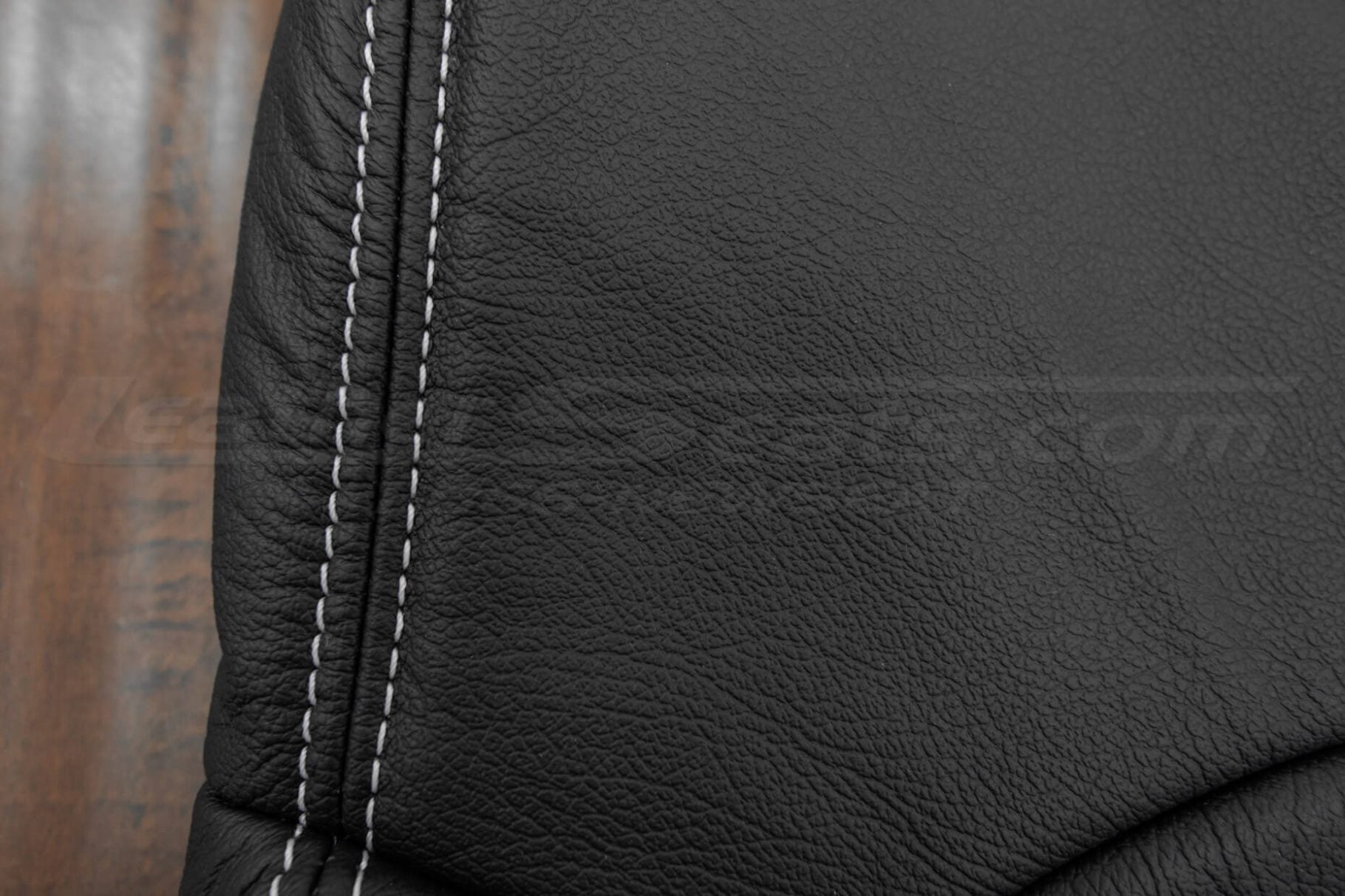 Silver double-stitching on black leather