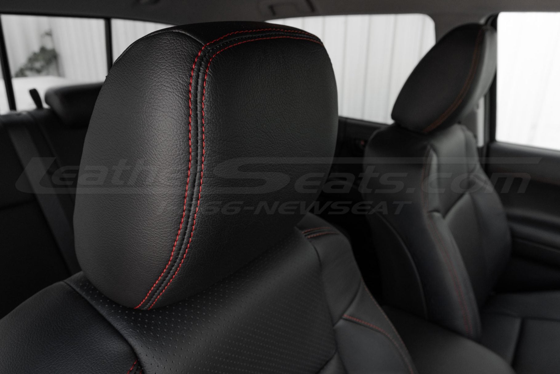Contrasting Cardinal Red double-stitching on Black tacoma headrest cover
