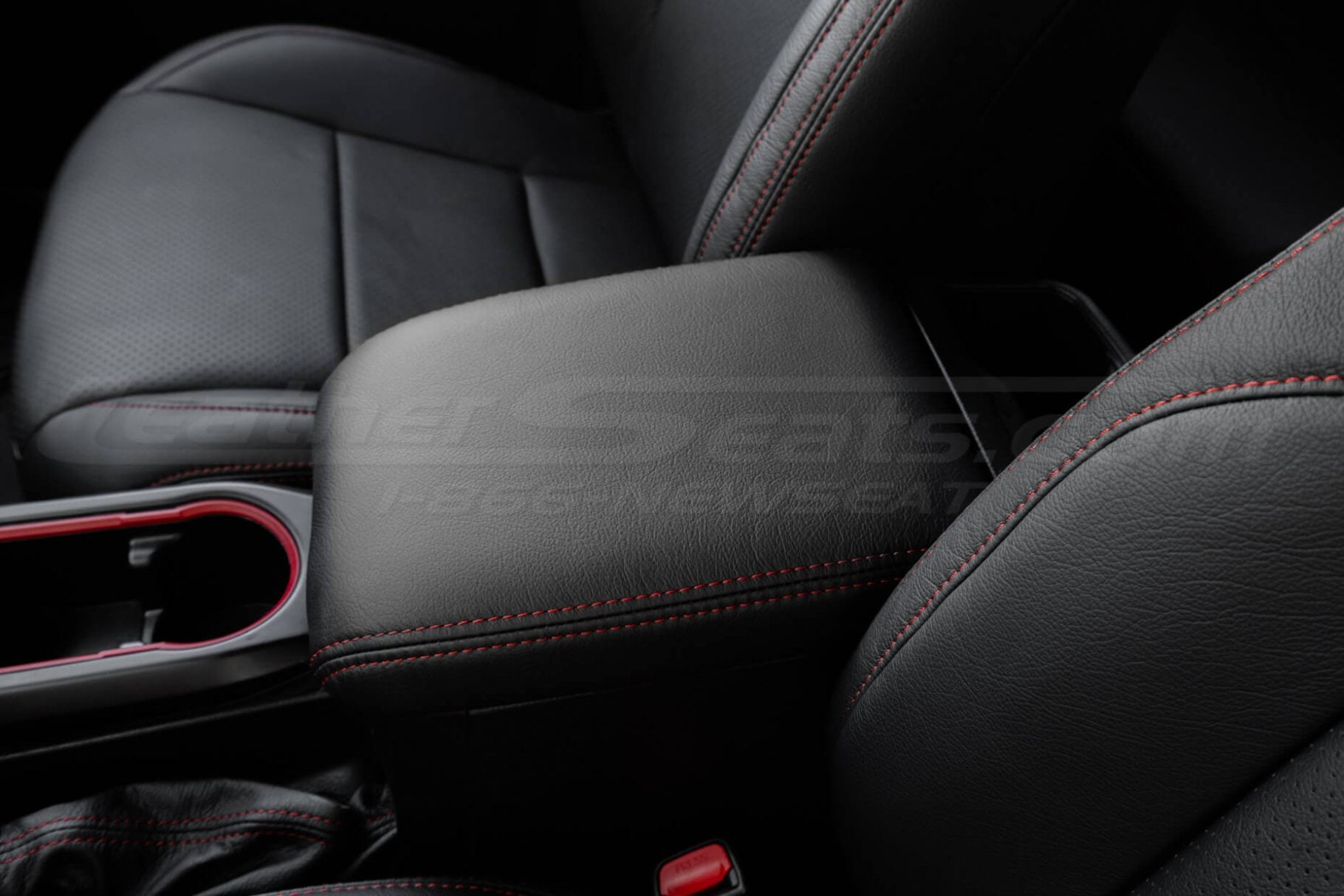 Driver side view of aftermarket leather center console covver for toyota tacoma