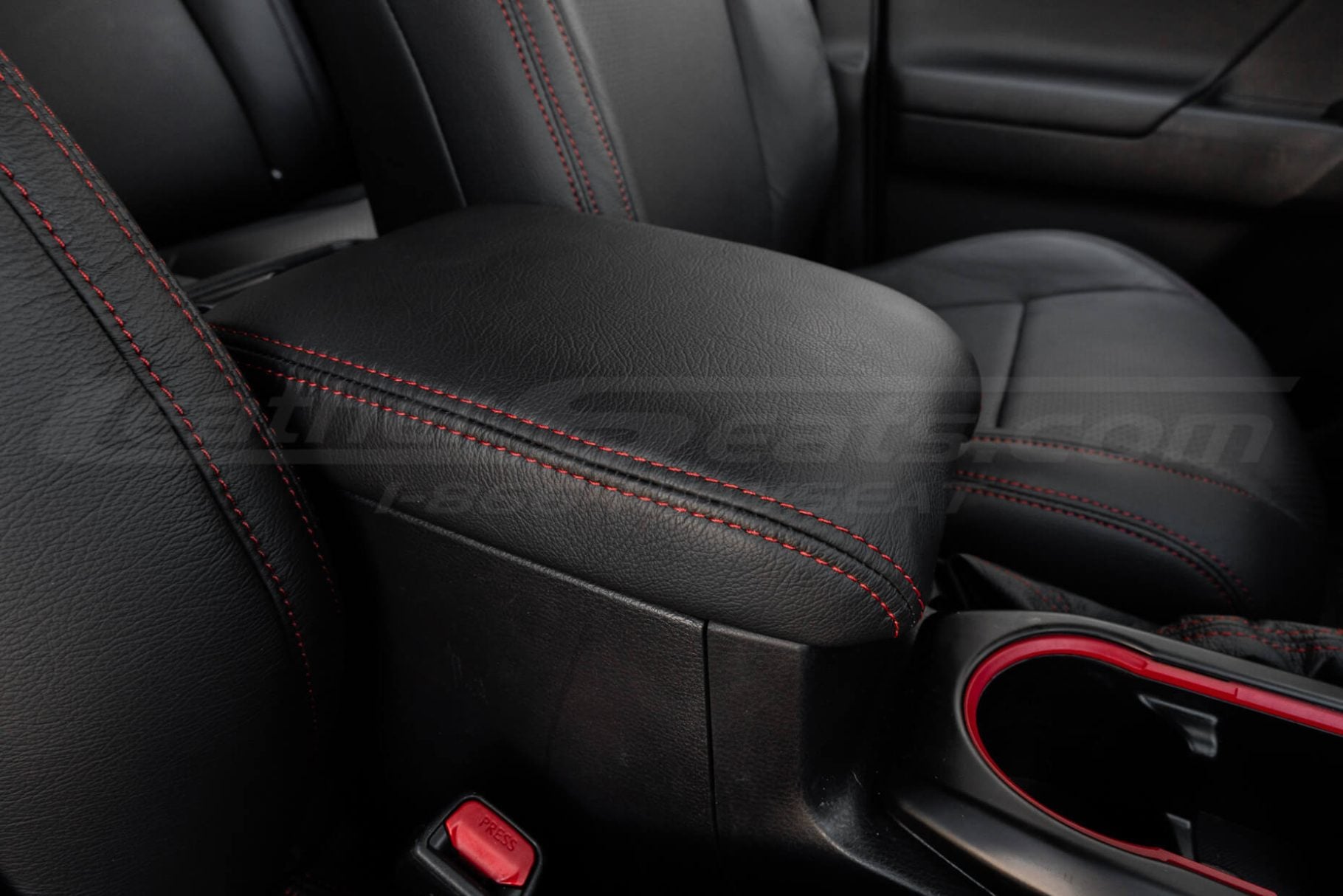 Contrasting Red double-stitching on Black toyota tacoma center console lid