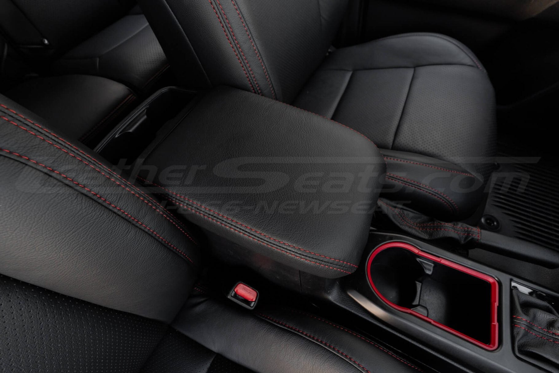 Black Toyota Tacoma leather console lid with contrast red stitching