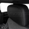 Black leather headrest with contrasting double-stitching close-up