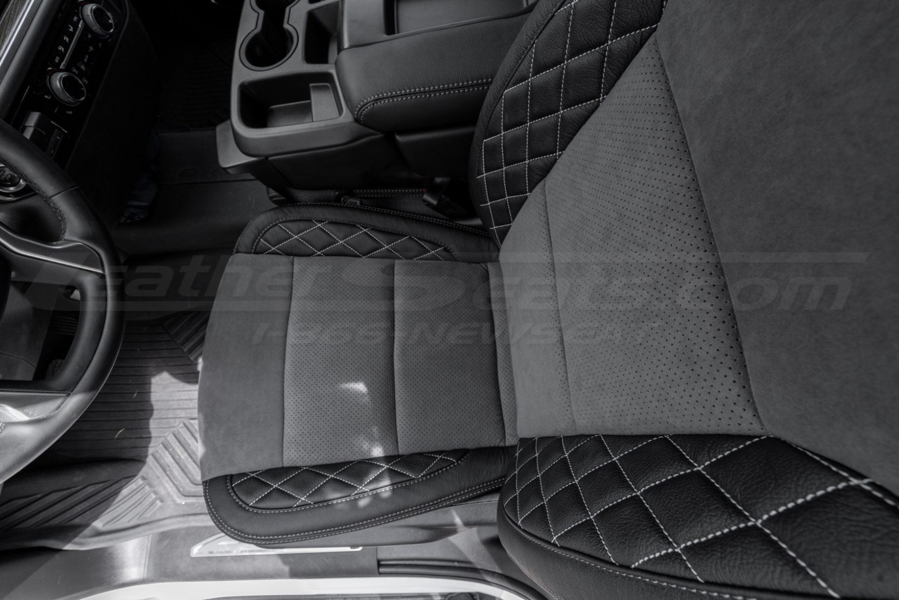 Top-down view of silverado driver seat with aftermarket leather and suede installed