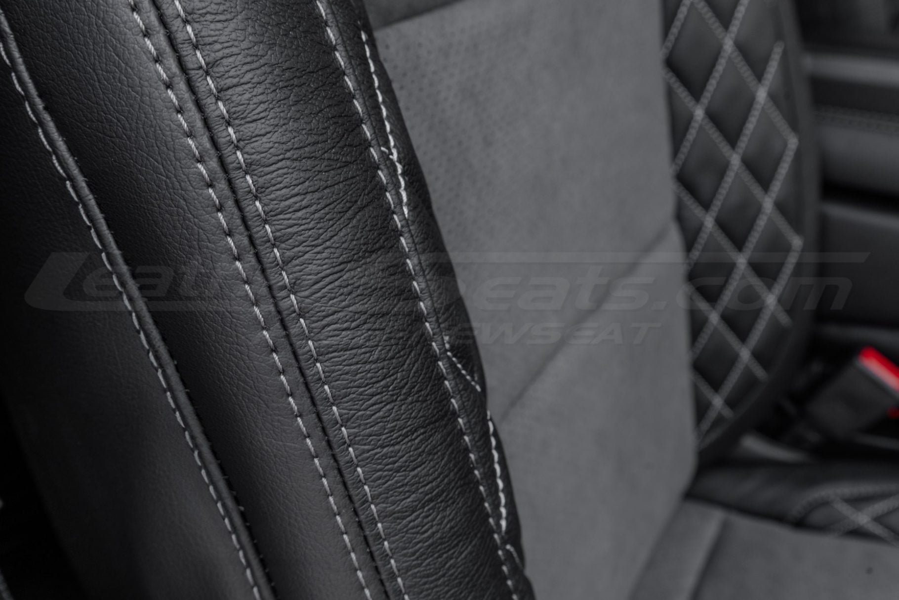 Contrasting Lapis double-stitching on black leatherr close-up