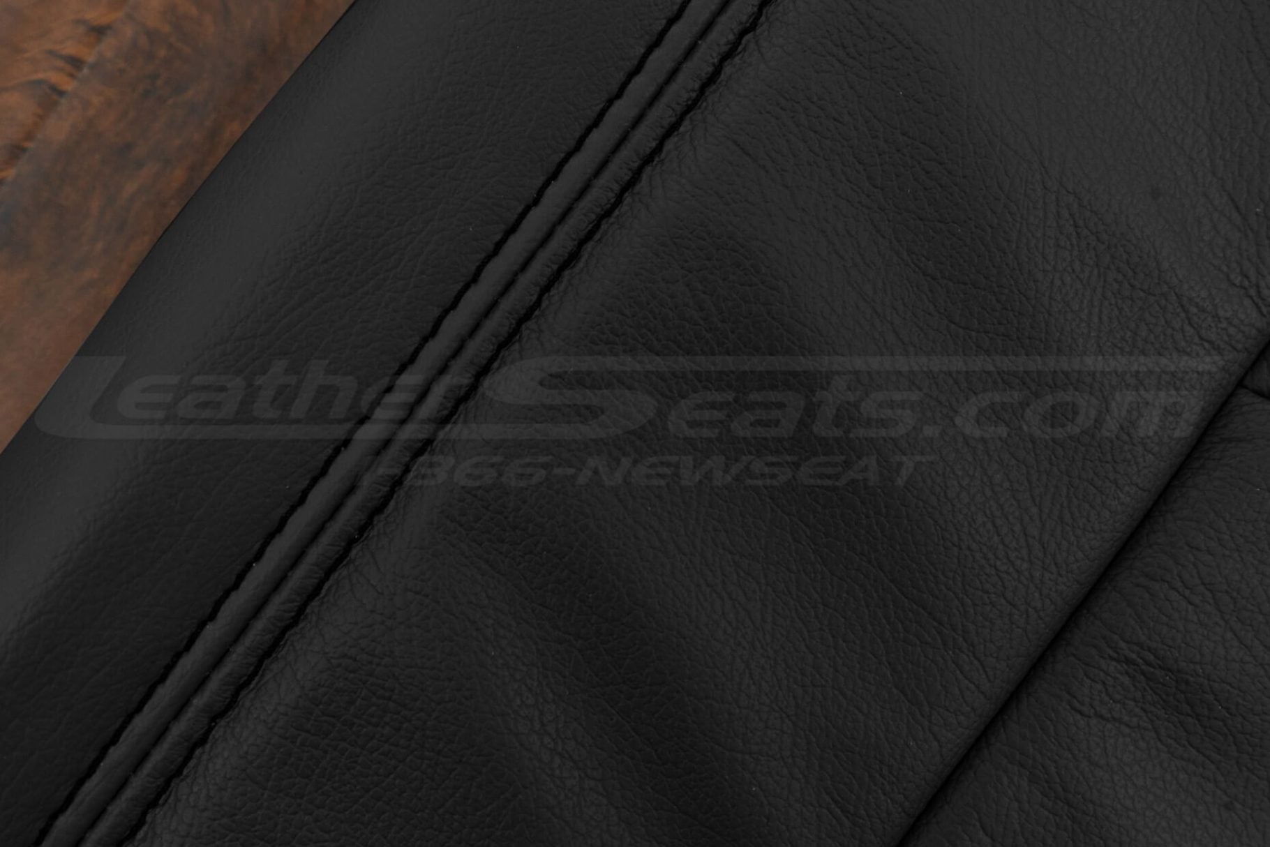 Black double-stitching on black leather