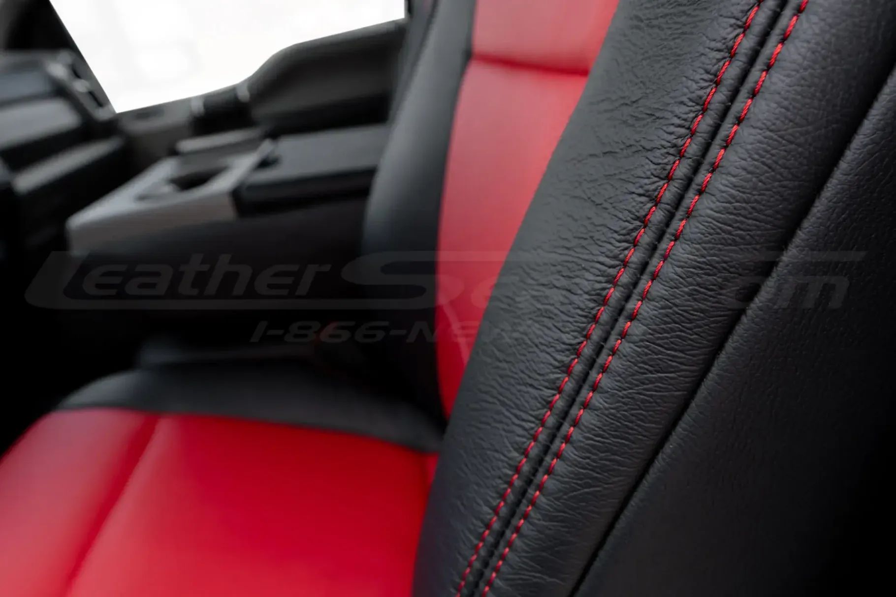 Red double-stitching on contrasting Black leather