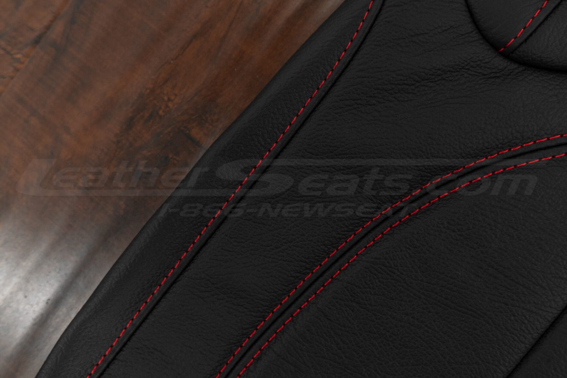 Red stitching on black leather