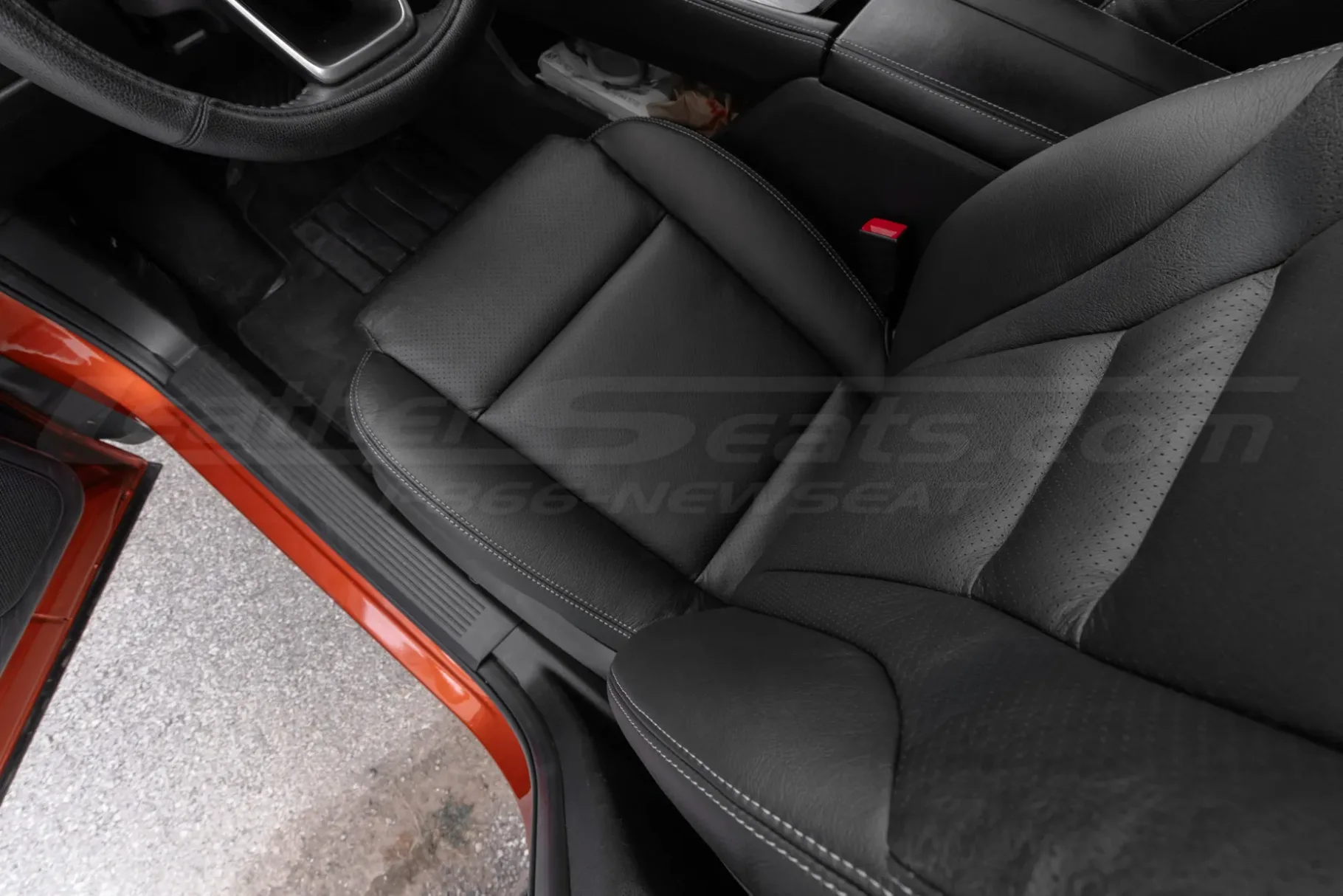 Top-down view of black Nissan Rogue leather seats with perforated body sections