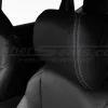 Black leather headrest with contrasting stitching close-up