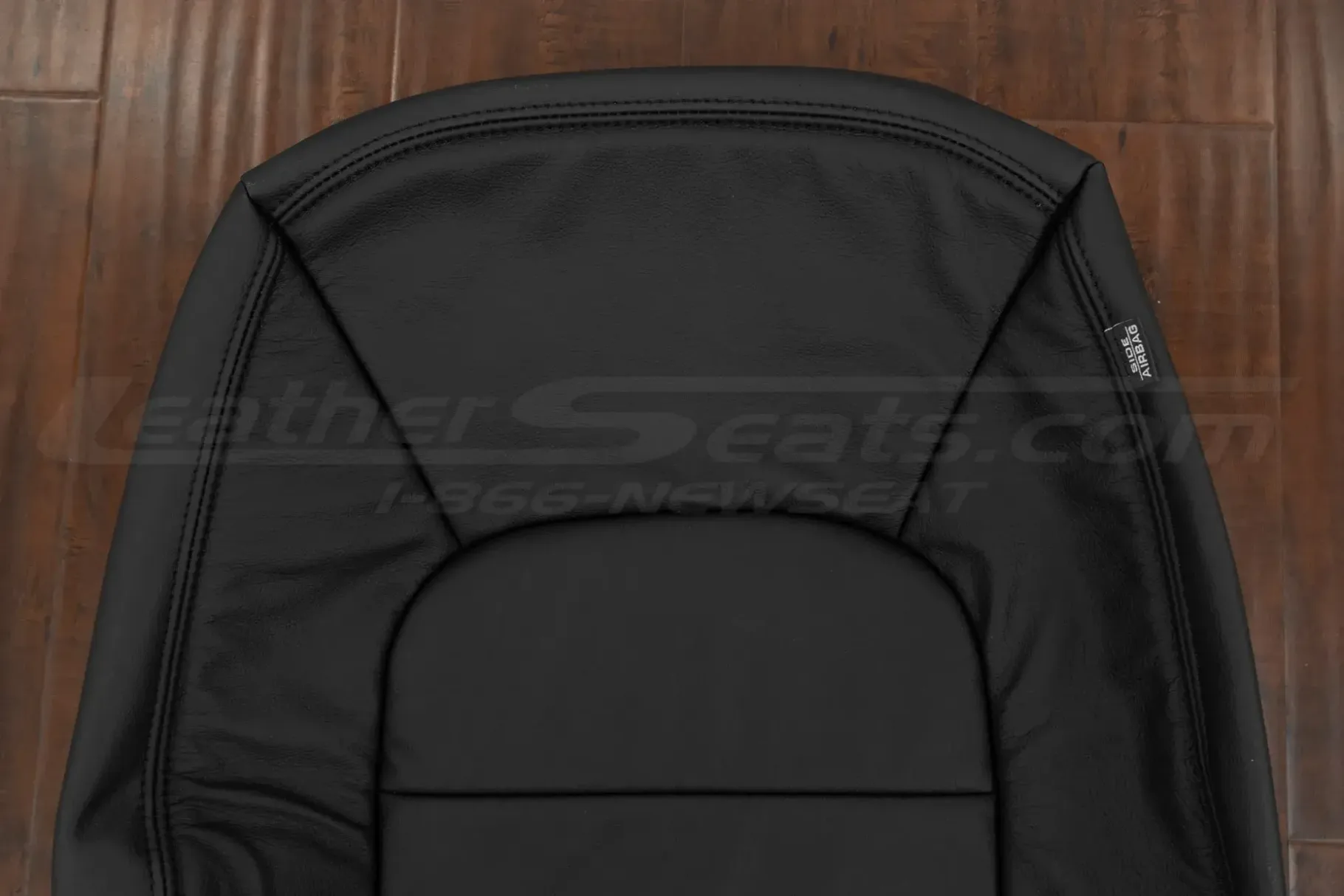 Upper section of black leather backrest upholstery