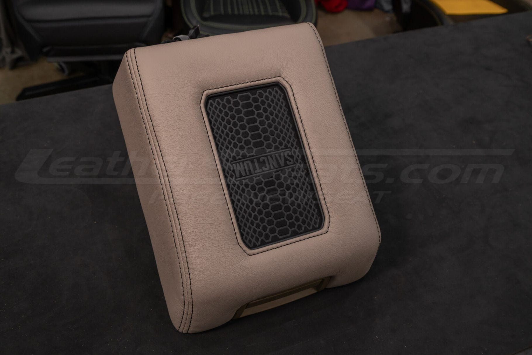 Leather center console lid with wireless phone charging pad