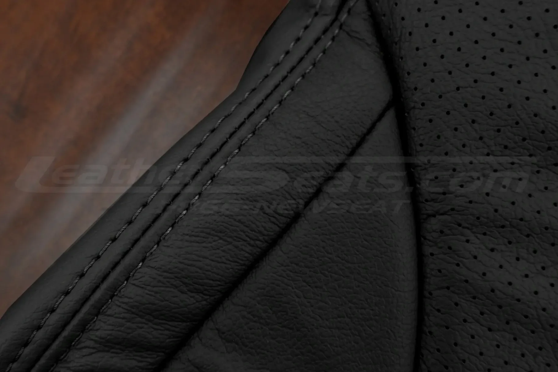 Matching black double-stitching on black leather