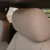 GMC Sierra leather headrest close-up with matching Sandstone stitching