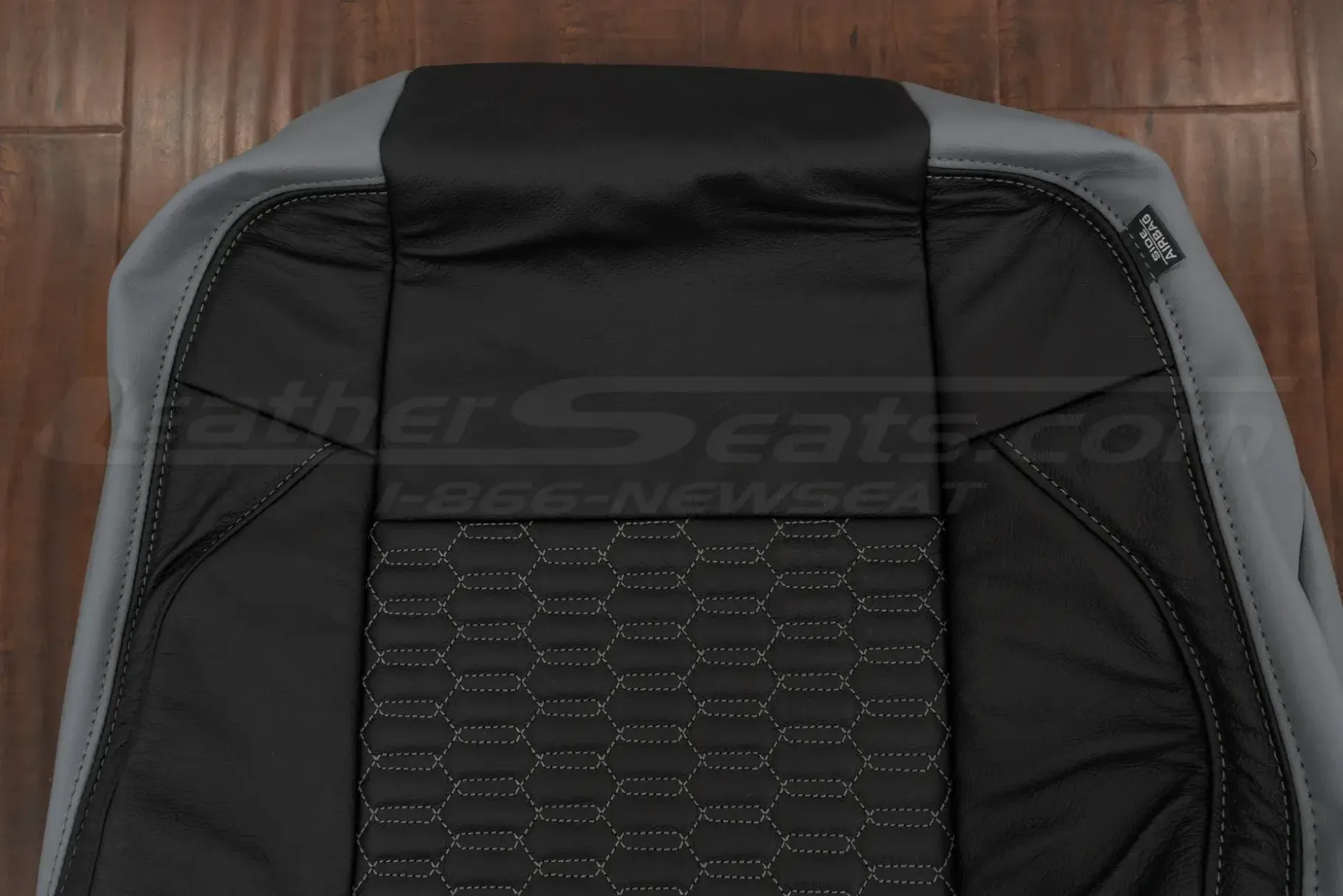 Upper section of leather backrest upholstery with quilted insert sections