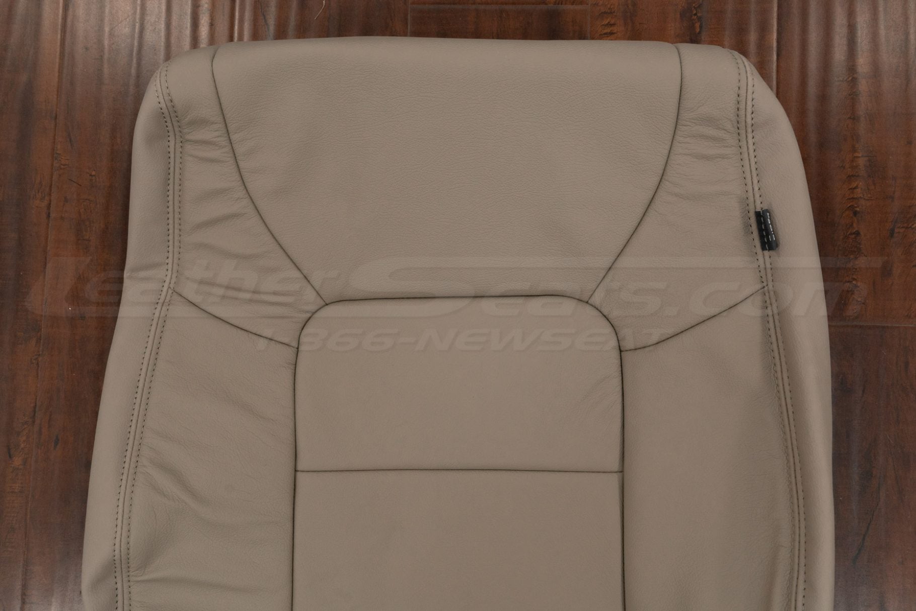 Upper section of beige leather backrest cover