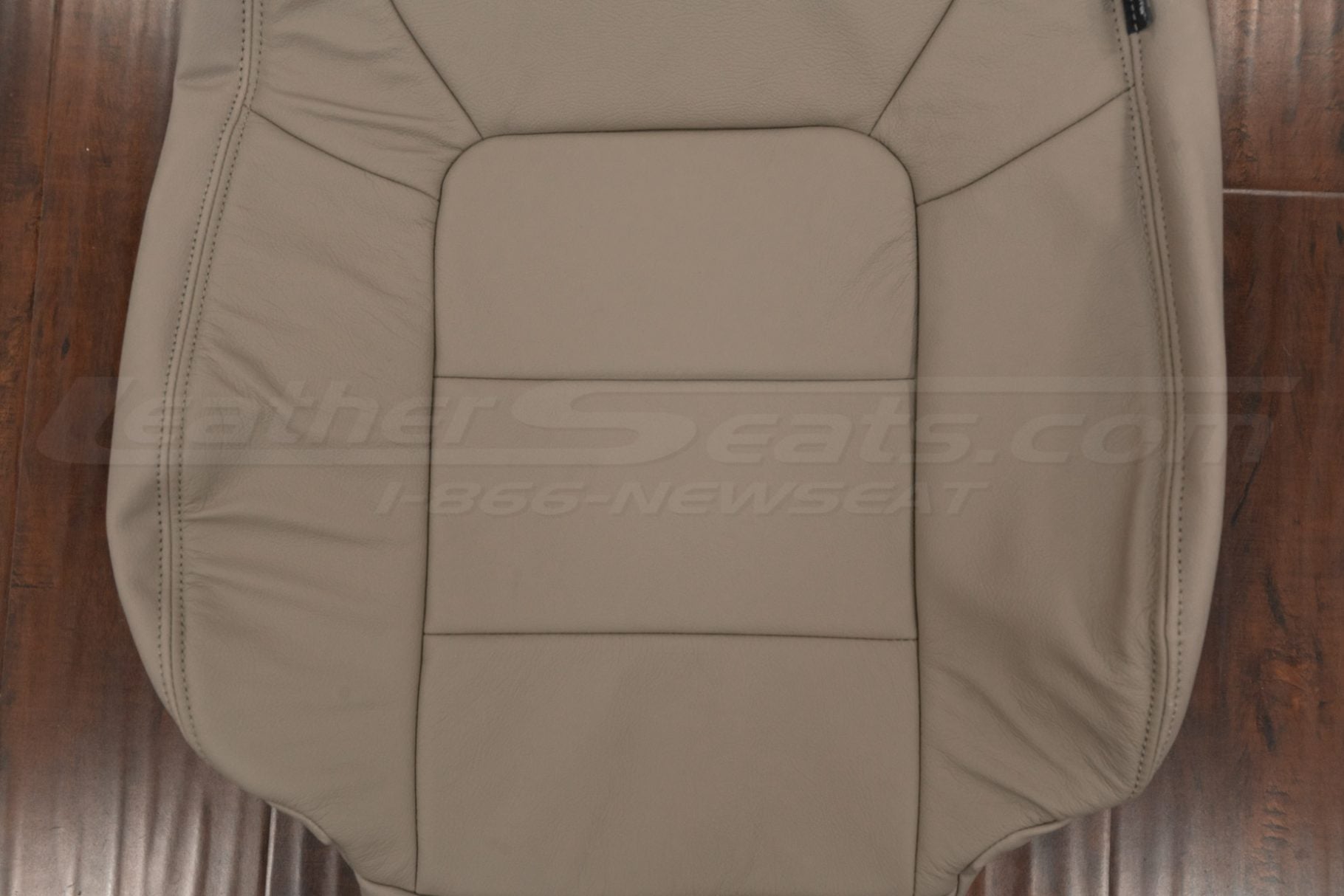 Beige insert section of leather backrest upholstery