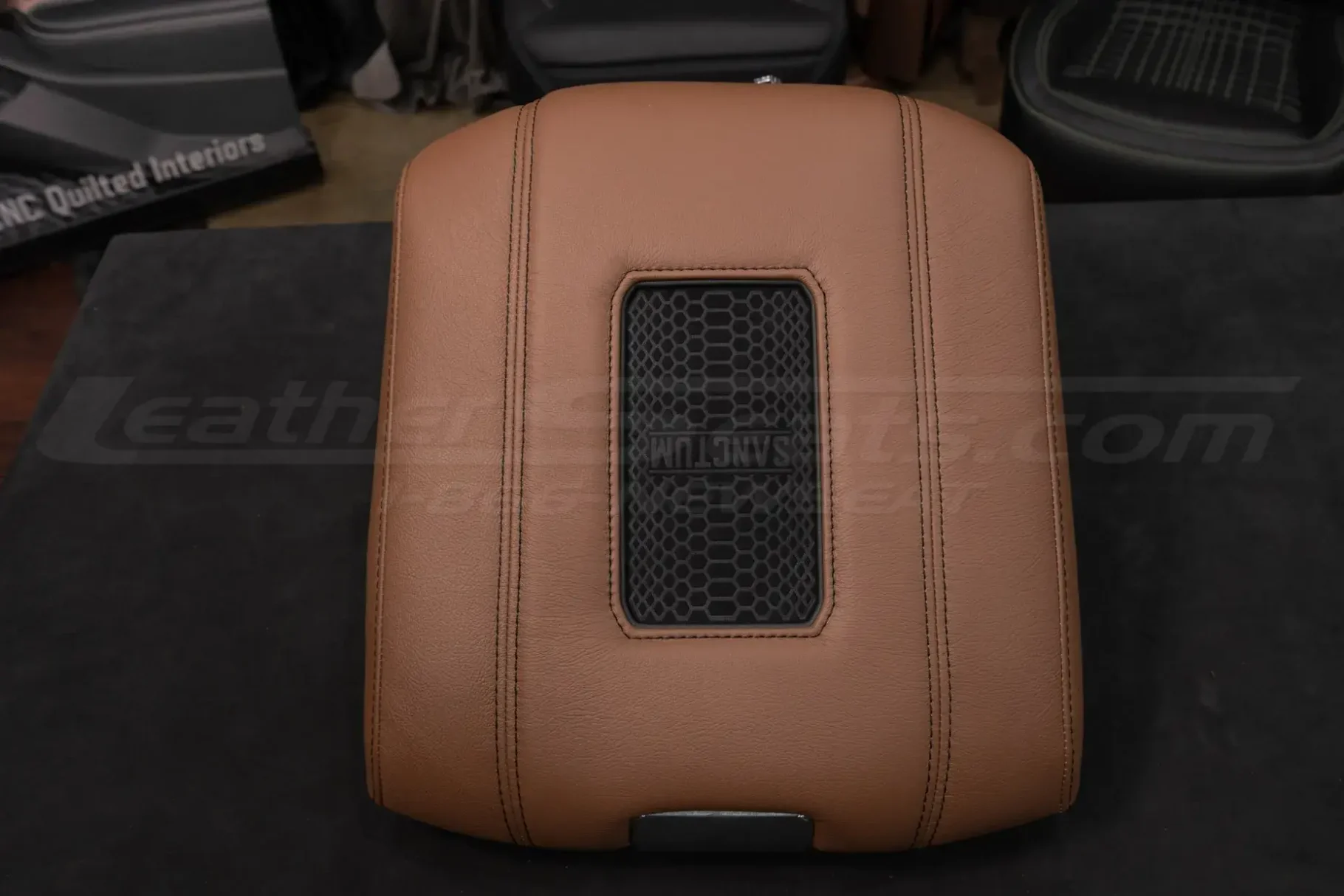 Cocoa leather charging console with dark graphite stitching and trim ring